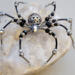 Handmade black and silver beaded spider ornament with iridescent accents and detailed wire legs, crafted by Beneath the Oak Designs.
